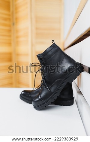 Black shoes lie on the floor. Winter black leather women's shoes.
