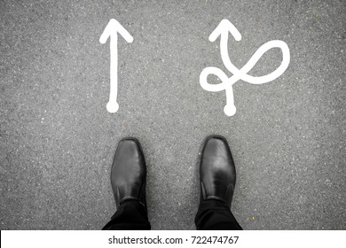 Black shoes standing at the crossroad and has to make decision which way to go for his success - hard way or easy way - Shutterstock ID 722474767