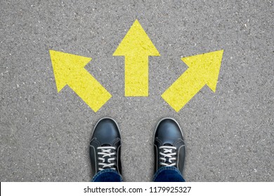 Black shoes standing at the crossroad making decision which way to go - three ways to choose. - Shutterstock ID 1179925327