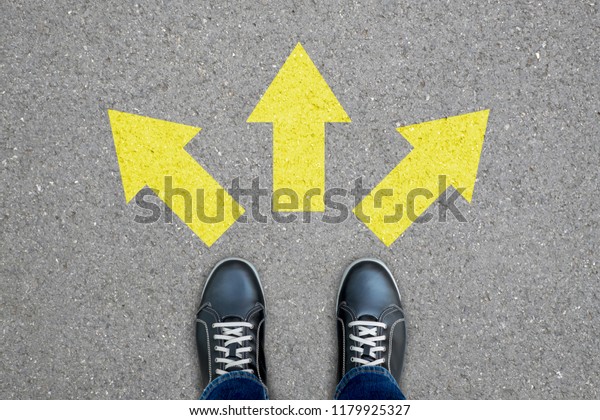 Black shoes standing at the\
crossroad making decision which way to go - three ways to\
choose.