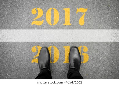 Black Shoes Standing At The Line Between Last Year 2016 And New Year 2017