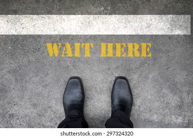 Black Shoes Standing At Wait Here Line