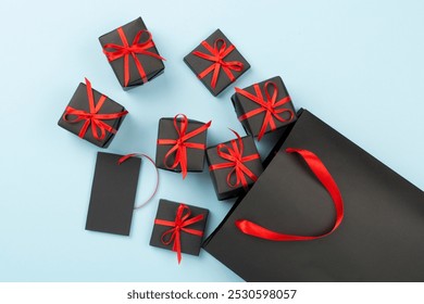 Black shopping bag and gift boxes on color background, top view.Black Friday concept - Powered by Shutterstock