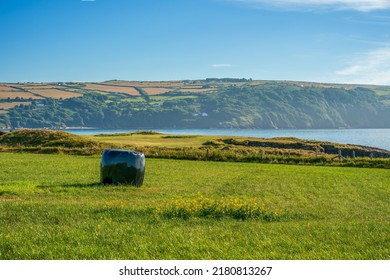 Black Shrink Wrap Waterproof Covered Bale Of Hay On A Coastal Farmers Field