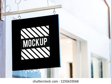 Black sign mockup outside a shop