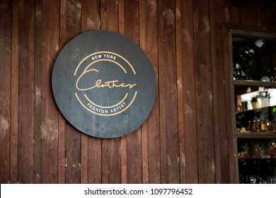 Black sign on a wooden wall mockup - Shutterstock ID 1097796452