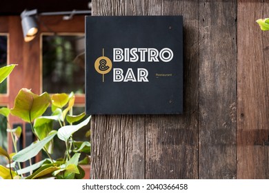 Black signage on a rustic wooden wall mockup