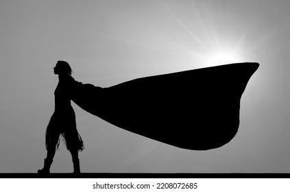 Black Silhouette Of Female Superhero Silhouette With Cape In Action Poses. Windy Weather. Isolated On White  Sky Background. Photo Of Female Super Hero. Woman Walking Against The Wind. Sun Rays