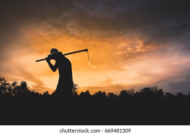 Black silhouette of a worker holding a hoe, Media image of commitment and hope - Powered by Shutterstock