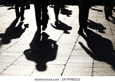 Black silhouettes and shadows of people on the street. Crowd walking down on sidewalk, concept of pedestrians, crime, society, city life - Powered by Shutterstock