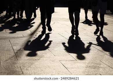 Black silhouettes and shadows of people on the street. Crowd walking down on sidewalk, concept of pedestrians, crime, society, city life - Powered by Shutterstock