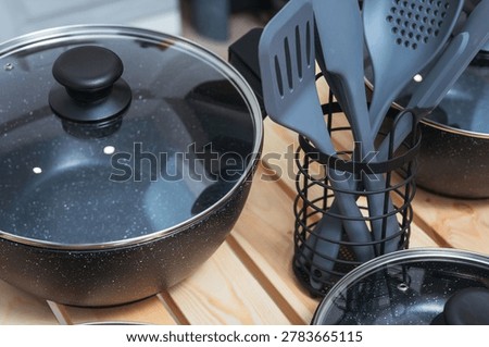 Black Silicone Tools With Organized Setup. Silicone Utensils Stored Neatly Near Cooking Pots