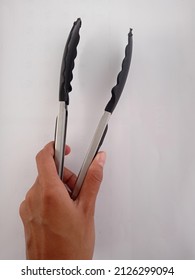 Black Silver Food Tongs On A White Background, Serves To Take Food