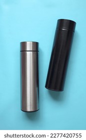 Black and silver water bottle. Aluminium reusable steel stainless eco thermo water bottle for mockup, isolated on blue background. Be plastic free. Zero waste.