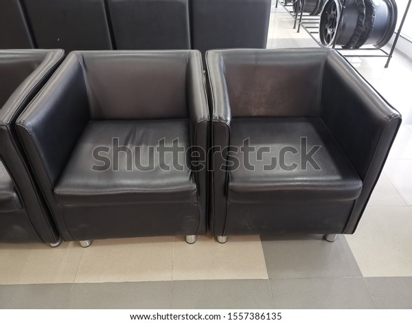 Black single sofas, armrest with silver legs arranged\
in a row
