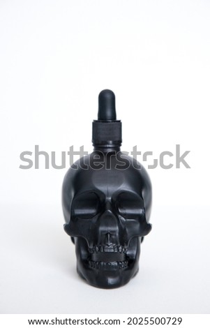 Black skull. Realistic essential oil. Set of black matte and glossy bottle.