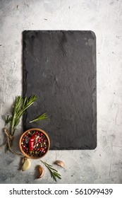 Black Slate Board, Herbs And Spices. Free Space For Menu Or Recipes. Cooking Or Food Background.