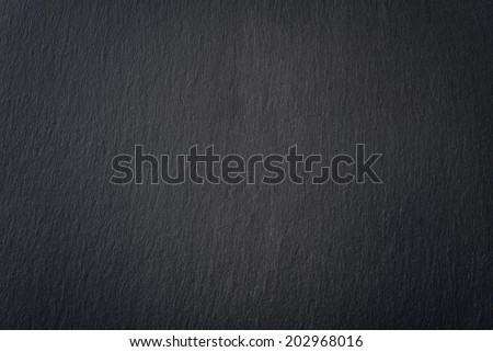 Black slate texture closeup. May be used as background