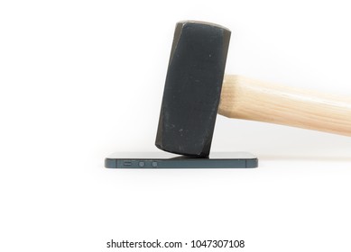 A Black Sledgehammer Sits A Smartphone Display That Is Lying Down Isolated On White.