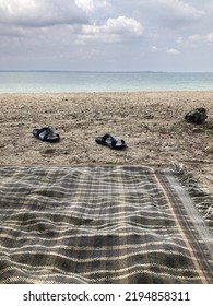 Black Slipper On The White Sand Of Panjang Island Indonesia