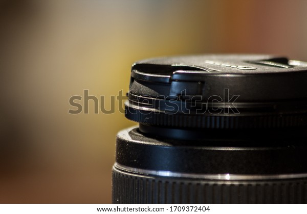 \
Black SLR camera lens top\
with cap