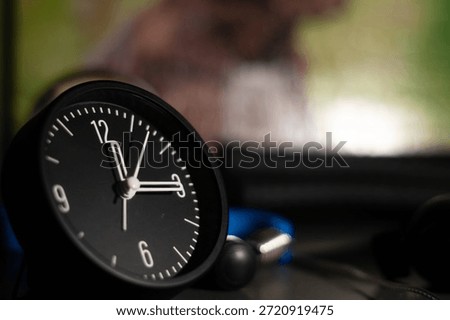 black small clock with a beutiful bokeh