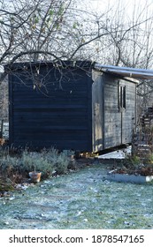 Black Small Garden Shed In Winter Frosty Garden