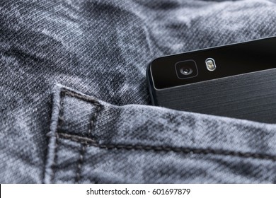 black smart phone in jeans pocket,smart phone camera isolated on jeans texture