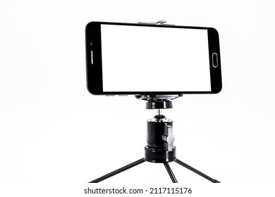 Black Smartphone Cell Phone In Horizontal Position Filming And Photographing Something With Tripod, Isolated Background, White Canvas For Mockup, Copy Space