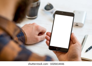 A black smartphone mock up in the hands of a man on a white background, concepts of Internet commerce and the use of online banking to pay for services and goods in Internet. digital