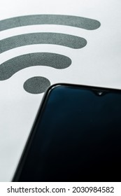 Black Smartphone On A White Background And A Black Wifi Symbol 