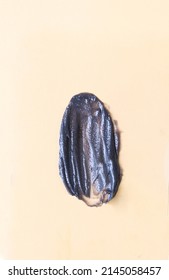 Black Smear On Beige Background. Clay Mask, Thermal Cleansing Balm,  Coal Cosmetics For Skin Care.    Flat Lay Top View