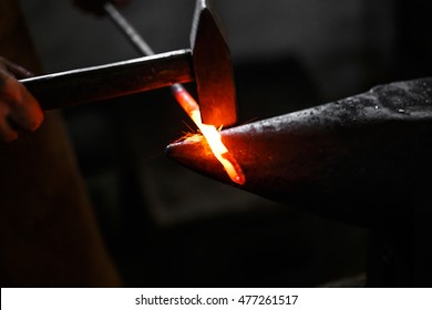 Black Smith, Ironsmith Hitting Hotsteel On An Anvil In A Retro Smithy 