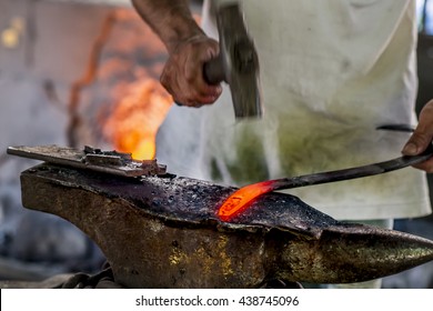 Black smith,Ironsmith hitting hotsteel on an Anvil in a Retro smithy in Chiang Mai Thailand - Powered by Shutterstock