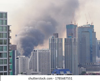 Black smoke caused by a fire in a downtown Bangkok building, Danger from using electricity or broken electrical wires, Selective focus.