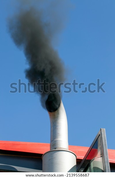 black smoke coming out of the pipe of a working\
car, a large amount of emissions of harmful substances from poorly\
functioning transport