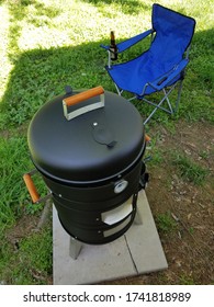 Black Smoker Grill With Blue Chair Bbq