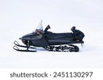 Black Snowmobile ski-doo. Skidoos parking in the snow-white yard. For Riding through the ice. It is a vehicle for driving on snow or ice and for racing sports extreme.