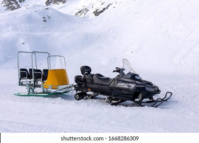 Black Snowmobile With Trailer For Passengers.Passo Del Tonale.Italy.02.20.2020.