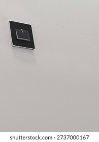 black socket switch on white wall