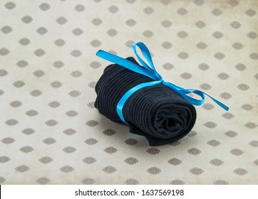 black socks rolled up on a colored background