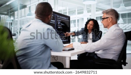Black Software Engineer Debugs Code On Office Computer Screen.