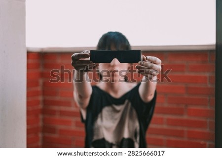 Black solar eclipse viewing glasses with dark protective lenses, designed for observing the sun during a solar eclipse. Astronomy accessory for safe solar observation 