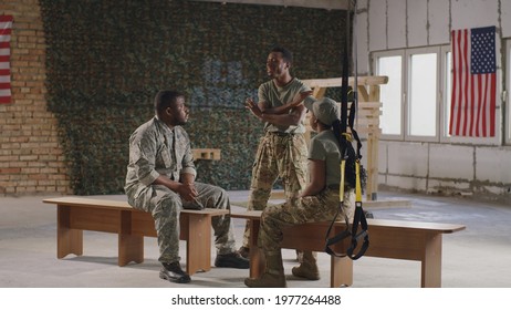 Black soldier talking with squadmates in gym - Powered by Shutterstock