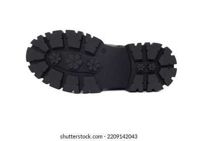 Black Sole Shoe , Isolated On A White Background. Fragment Of Boots With Large Protektor. Tread Pattern On Sole. Making And Sale Of Casual Shoes. Sale Of Shoes Anti-slip Protector.