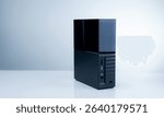 Black solid state external hard drive on white background, perfect for digital data storage and fast backup solutions in modern offices, tech workspaces, and remote setups. Portable SSD device.