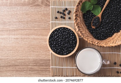 Black Soy Bean Seeds And Soy Milk On Wooden Background, Table Top View, Healthy Drink