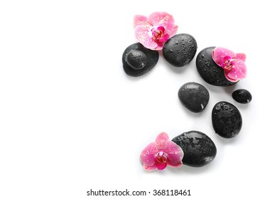 Black Spa Stones And Orchids Isolated On White