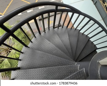 black spiral staircase in the shape of a downward spiral