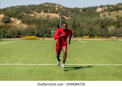 Black Sportive Speed Runner, Running In A Football Field.